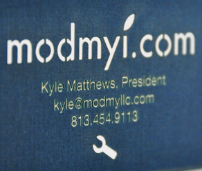 Laser cut business card showing detail of etching and linen texture 